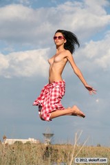 Skinny brunette jumping naked on the street 05