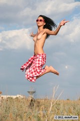 Skinny brunette jumping naked on the street 06